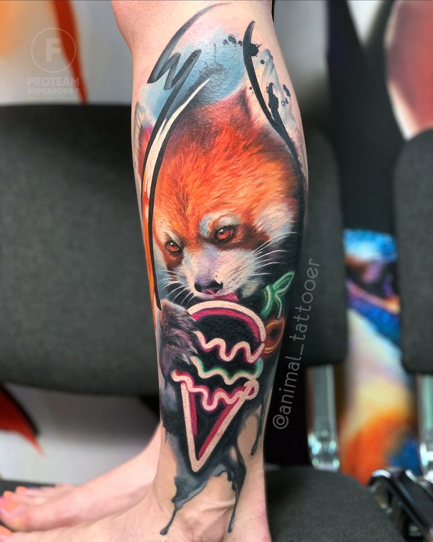 Colorful and bright animal tattoo of a fox with abstract design on a person's calf.