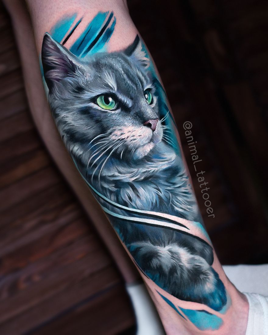 Colorful animal tattoo of a detailed cat on someone's forearm.