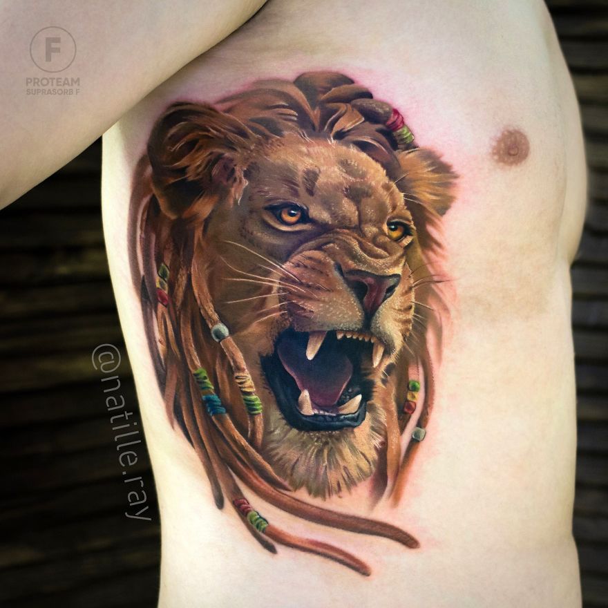 Colorful and bright lion tattoo on a person's side, showcasing detailed animal artwork.