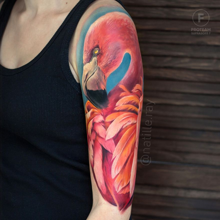 Colorful flamingo tattoo on a person's arm, showcasing vibrant animal art.