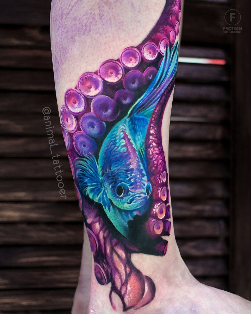 Colorful and bright animal tattoo of a blue fish and purple octopus tentacle on a person's leg.