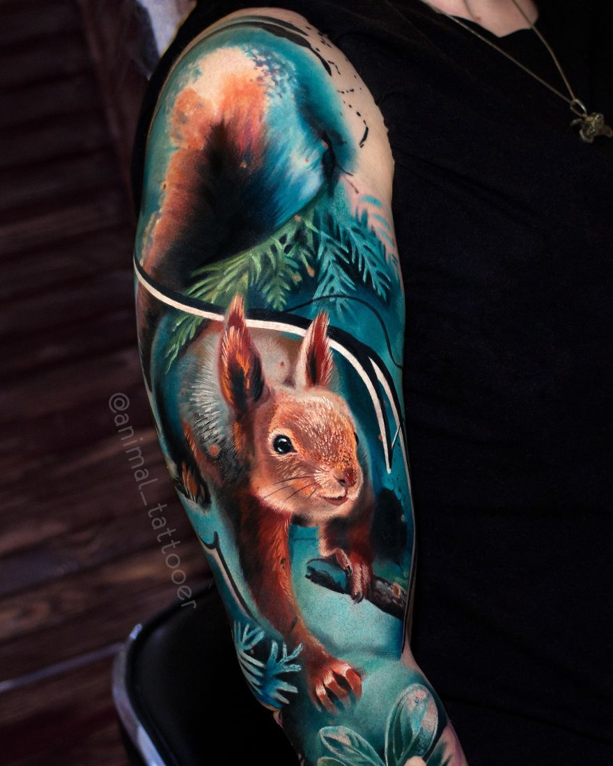 Colorful animal tattoo of a squirrel on an arm, featuring bright hues and detailed design.