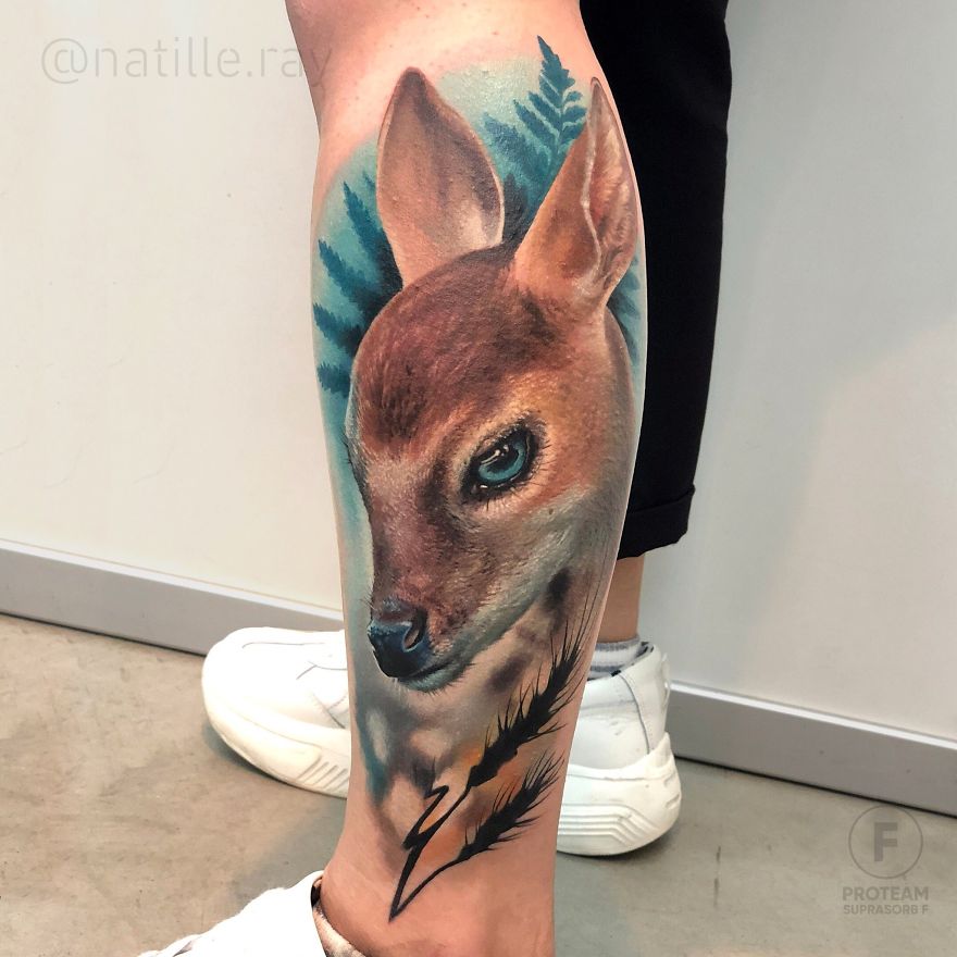 Colorful and bright animal tattoo of a deer on a person's leg, showcasing detailed artistry.