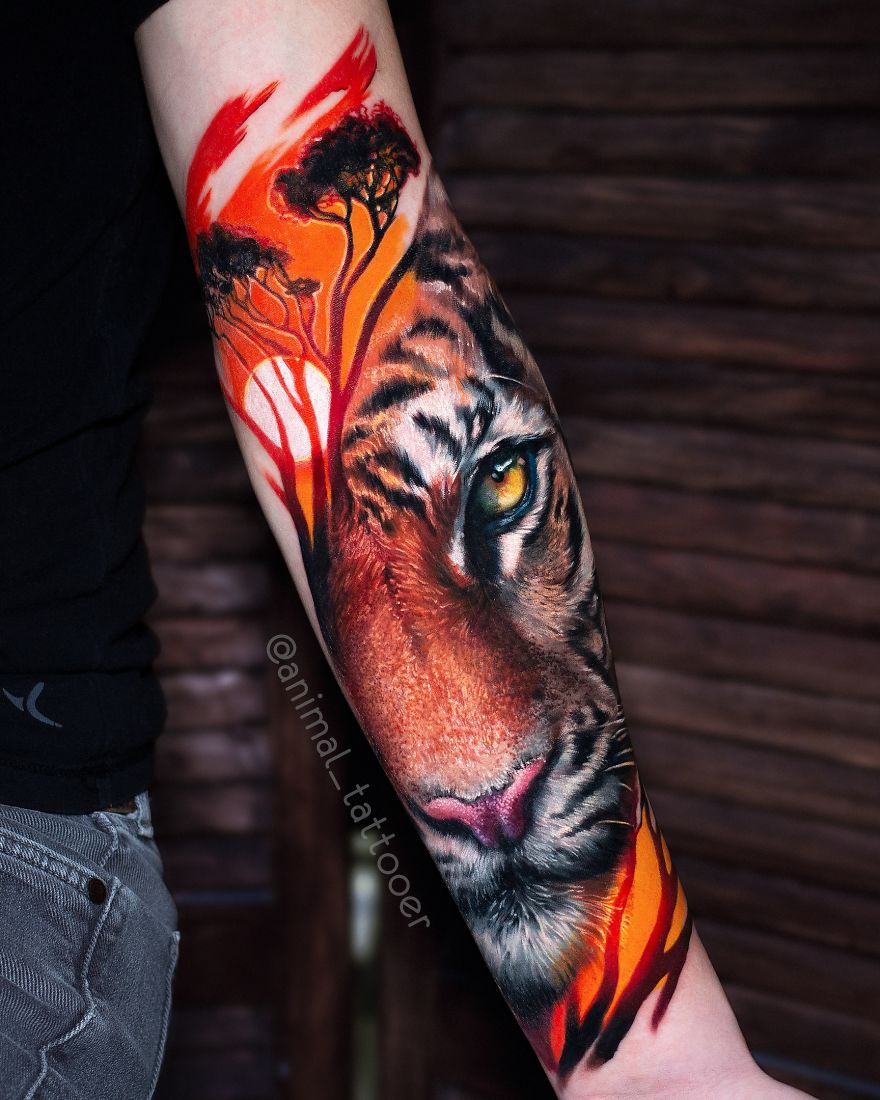 Colorful and bright tiger tattoo on a forearm featuring vibrant trees and intense colors.