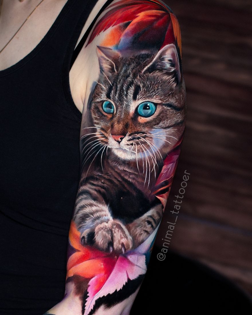 Colorful and bright cat tattoo on arm, featuring vibrant colors and detailed design.