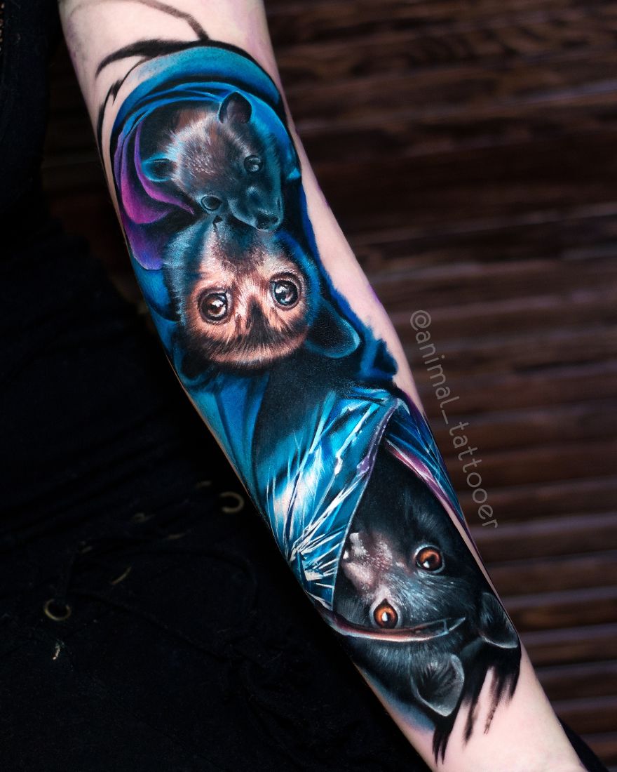 Colorful and bright animal tattoo of bats on a person's forearm, showcasing vibrant detail and artistry.