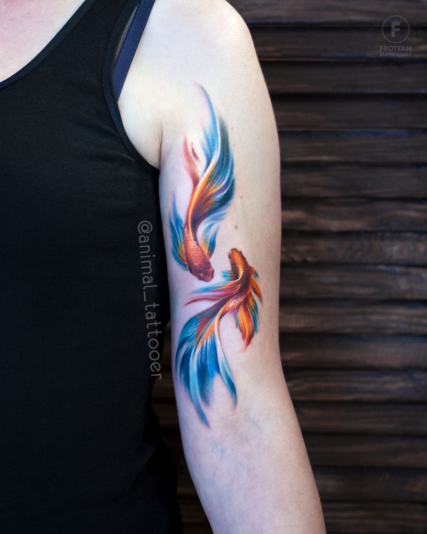 Colorful and bright animal tattoo of koi fish on a person's arm, showcasing intricate details and vivid hues.
