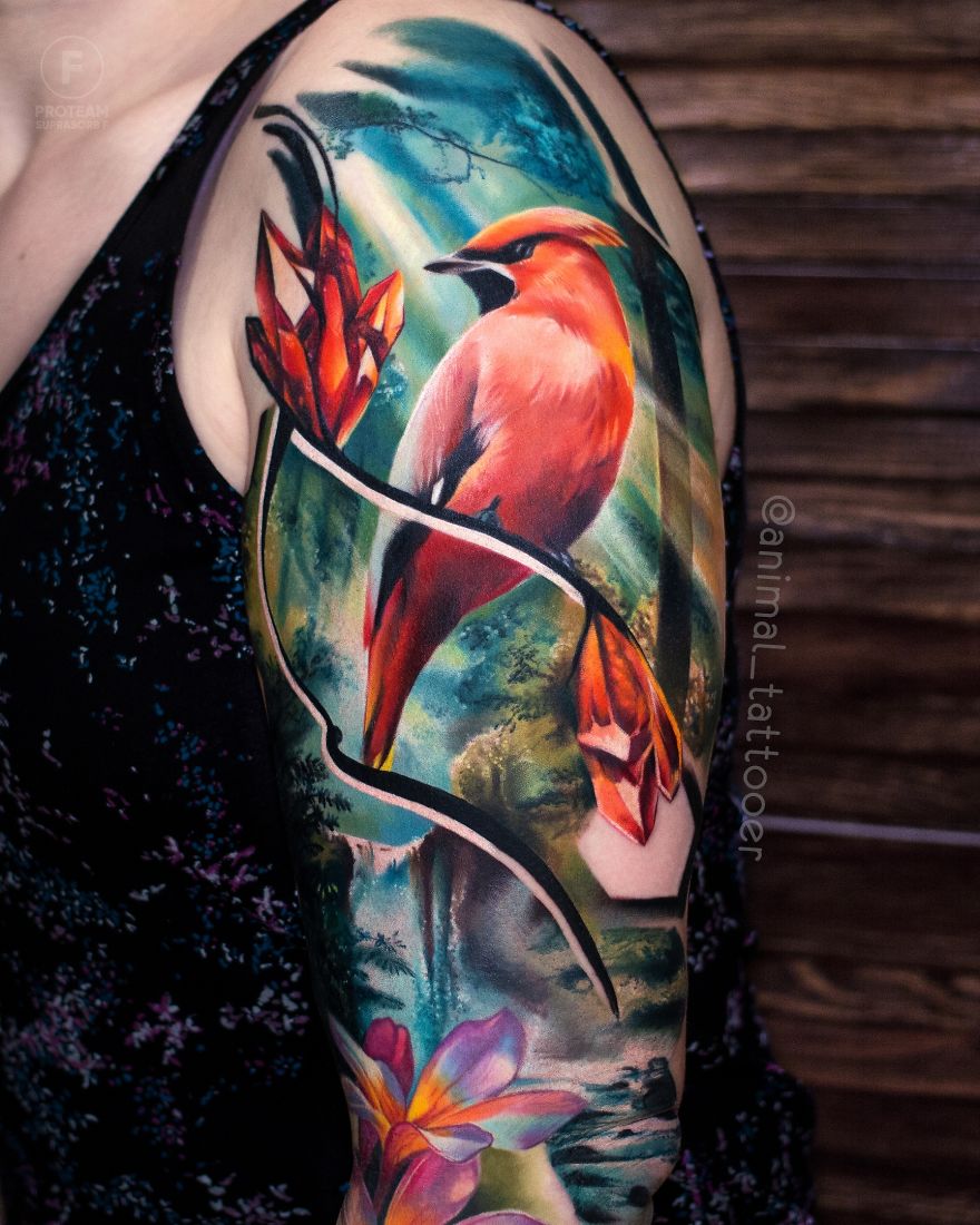 Colorful and bright animal tattoo of a bird with flowers on a person's arm, showcasing vibrant artwork.