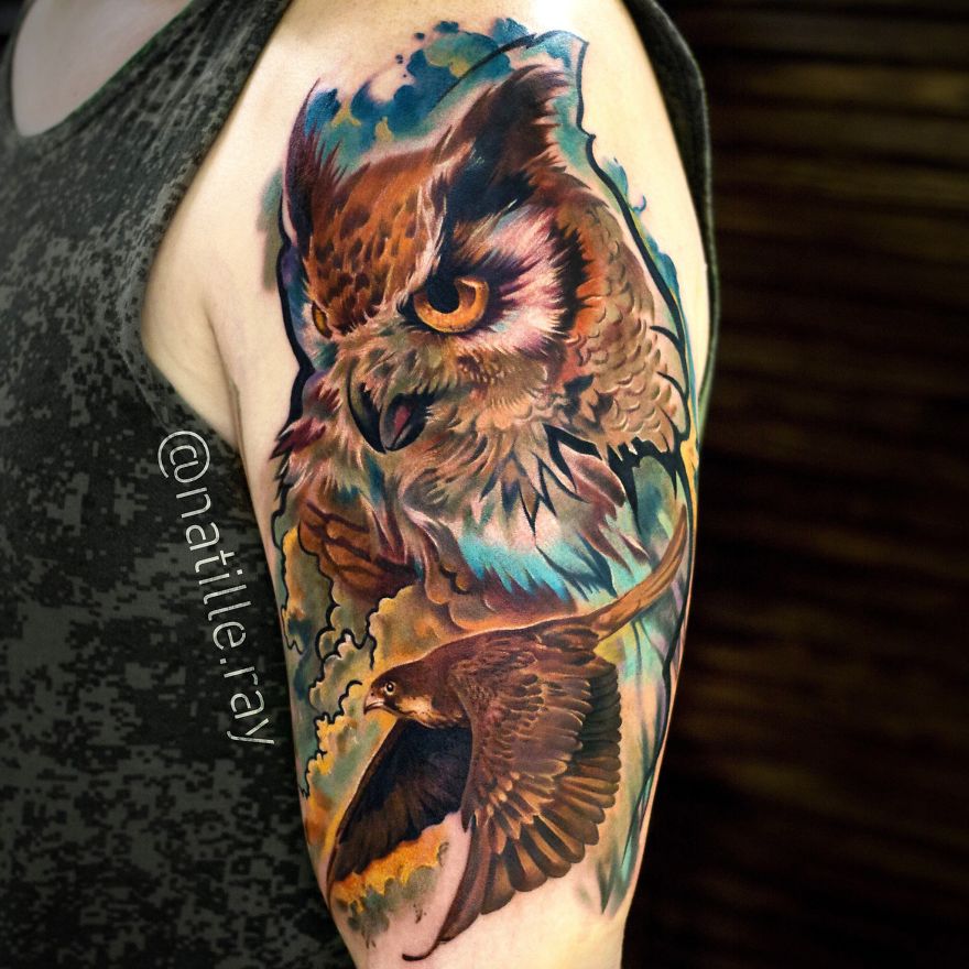Colorful and bright owl and bird tattoo on an arm, featuring intricate details and vibrant hues.
