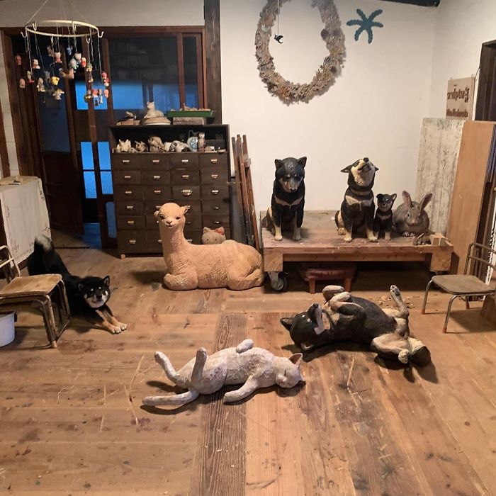 Cute Video Shows Dog Trying To Blend In Between Animal Sculptures