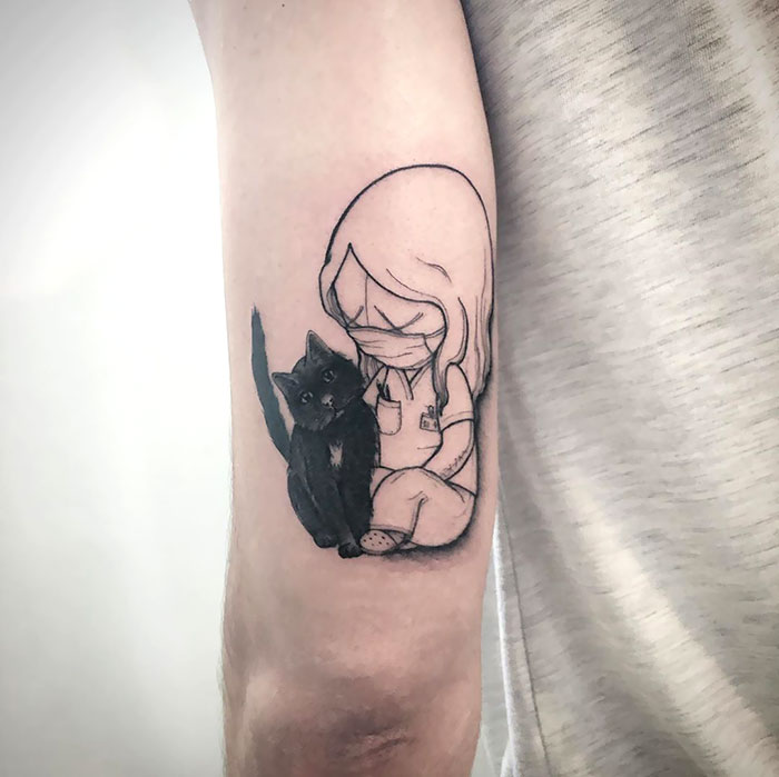 Creative Covid-19 tattoo featuring a healthcare worker with a cat on an arm.