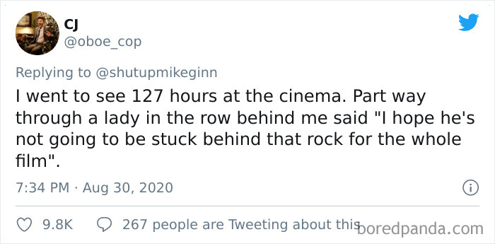 Tweet sharing a bizarre and dumb thing overheard in a movie theater during the film 127 Hours, highlighting weird cinema experiences.