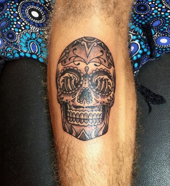 Skull tattoo design on leg, showcasing popular yet overly requested tattoo trend.