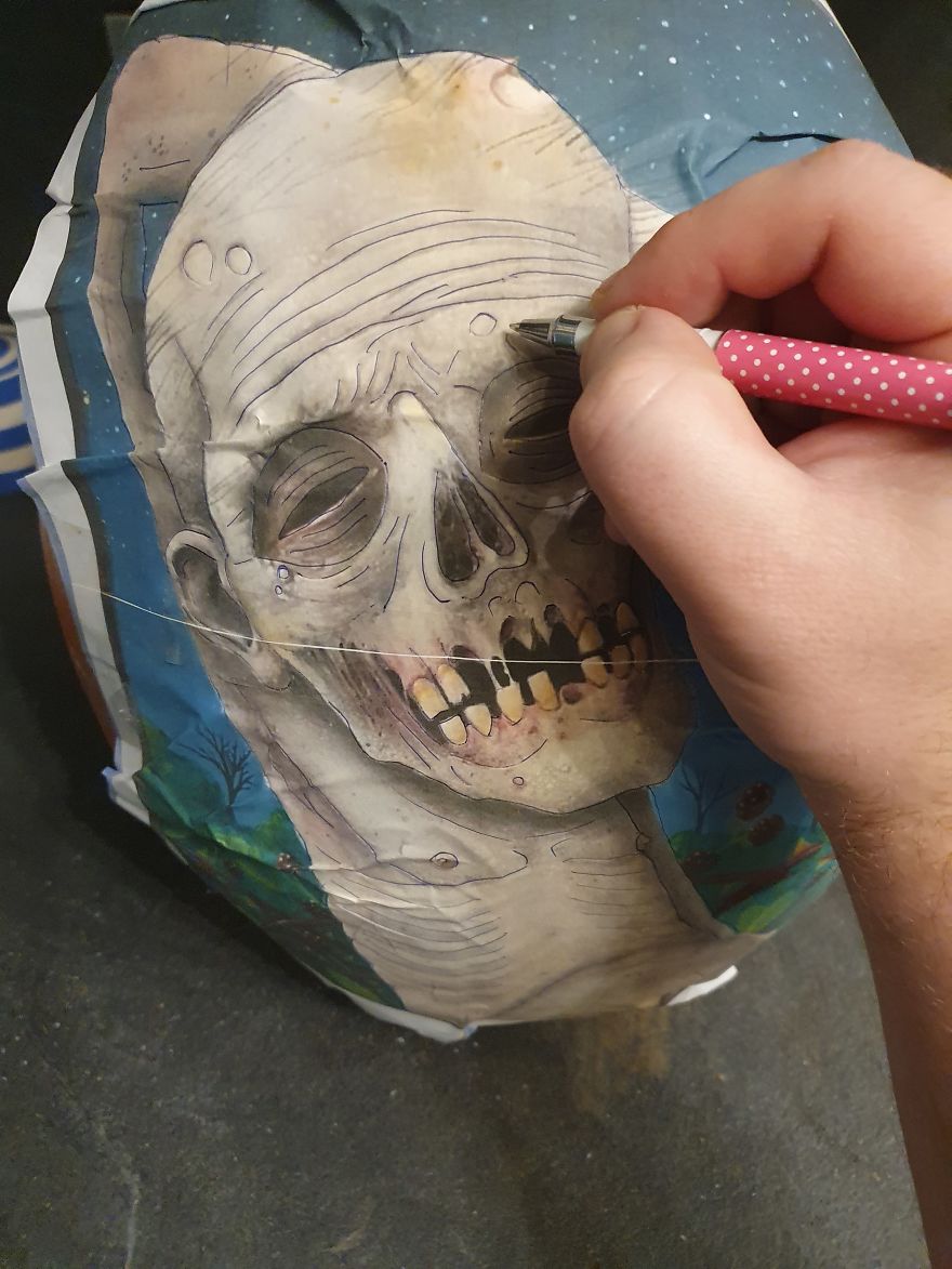 Hand tracing a skeleton design on a pumpkin for carving; showcasing effective pumpkin carving tips and hacks. Hand tracing a skeleton design on a pumpkin for carving; showcasing effective pumpkin carving tips and hacks.