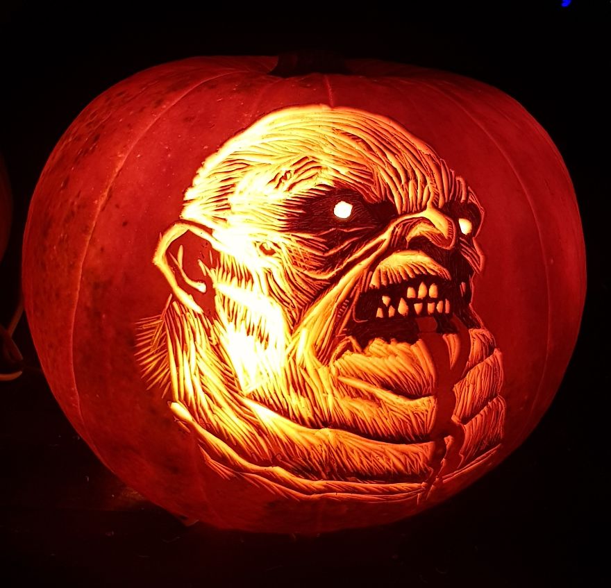 Horror scene character pumpkin carving with eerie, glowing face.