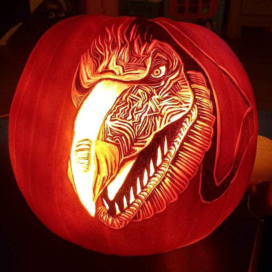 Pumpkin carving depicting a horror scene character with intricate, scary details illuminated from within.