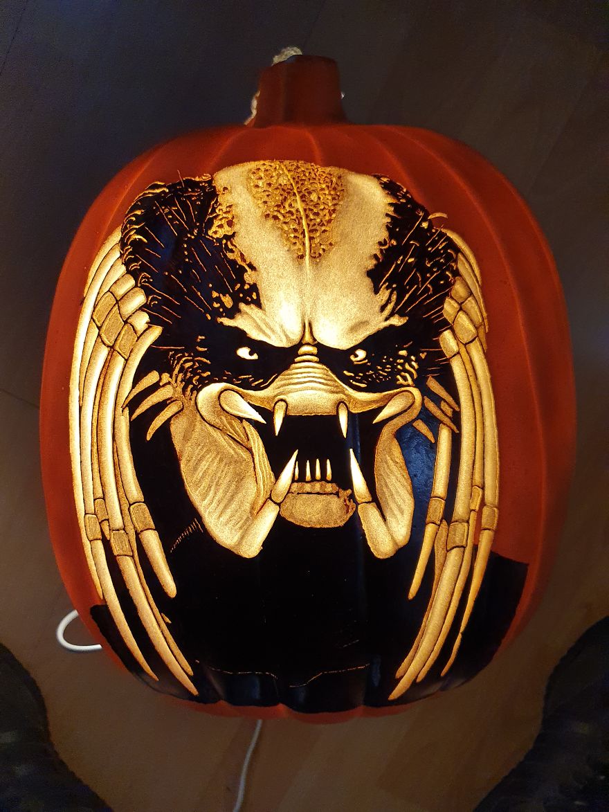 Pumpkin carving resembling a horror scene character with intricate details and a fierce expression.