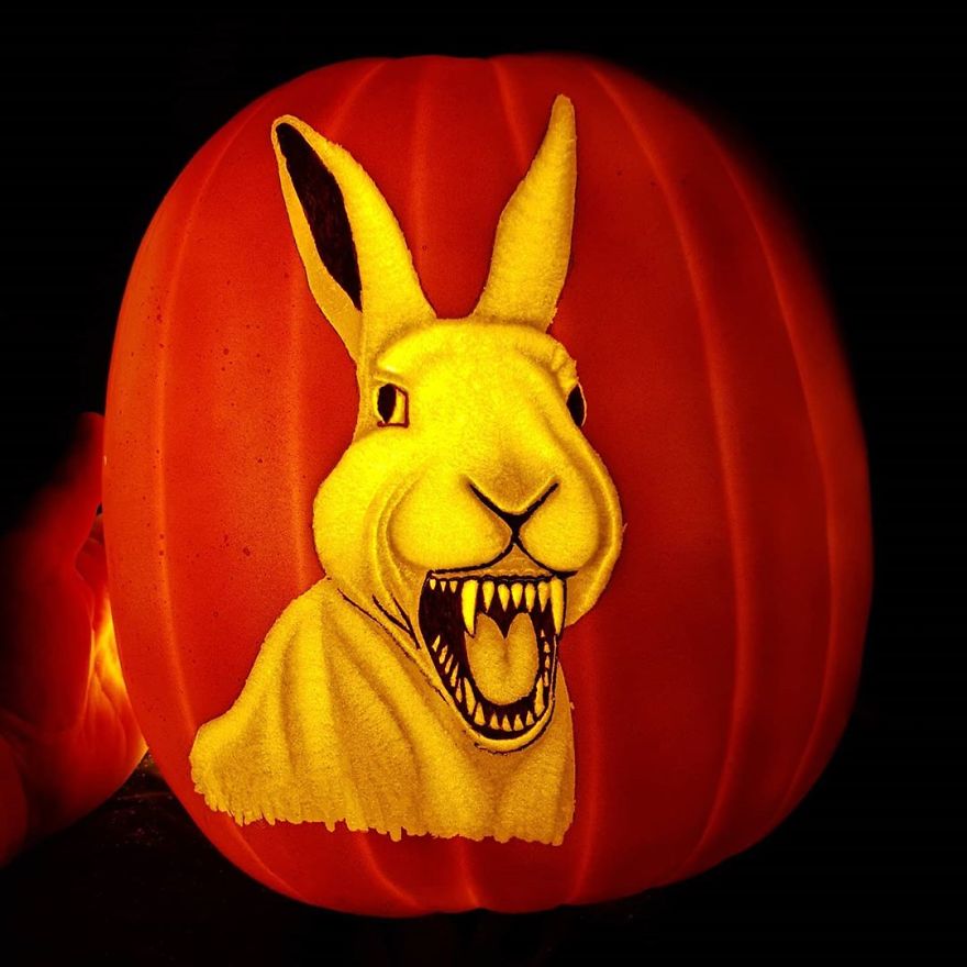 Pumpkin carving depicting a horror scene character, featuring a menacing rabbit with sharp teeth.