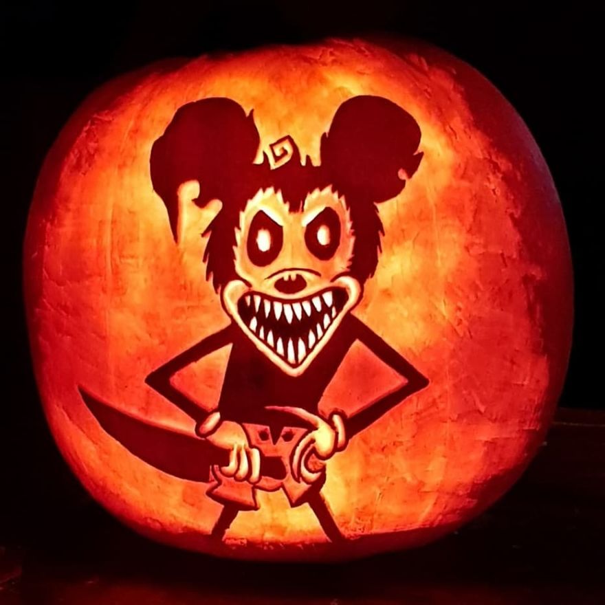 Horror scene character pumpkin carving with a sinister smile and outstretched arms.