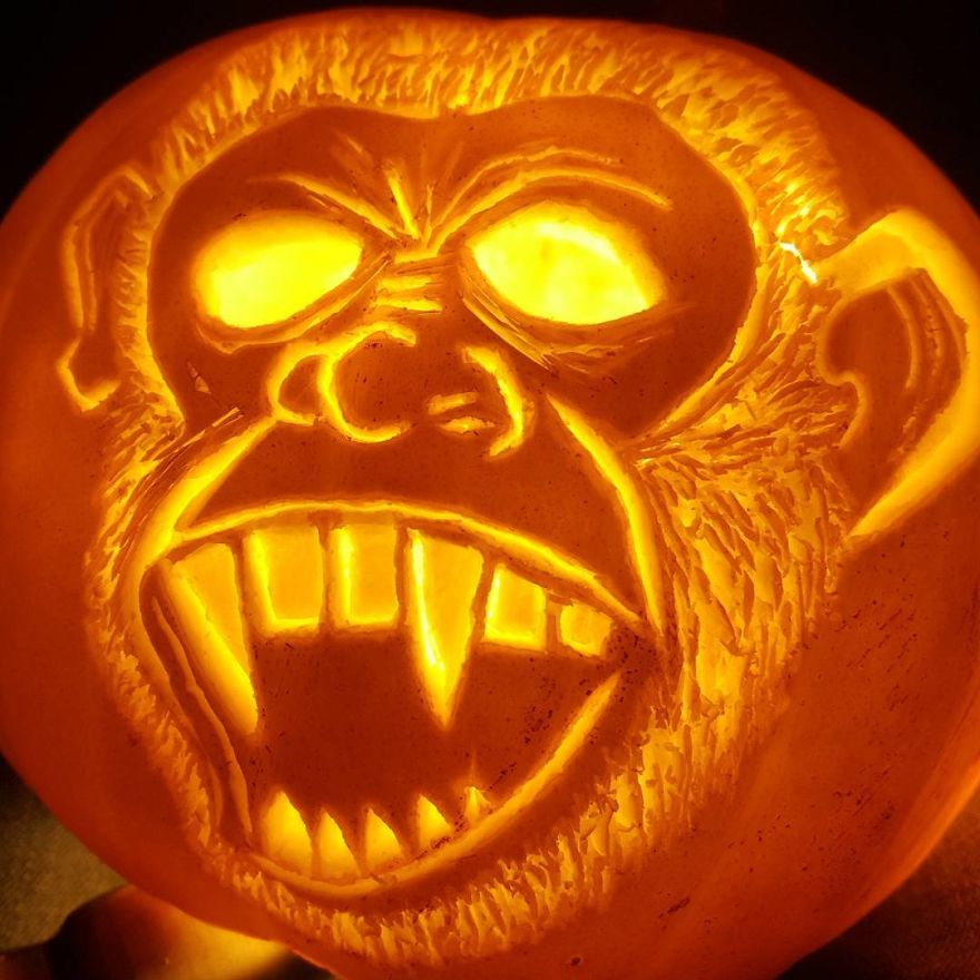 Pumpkin carving of a horror scene character with exaggerated features and glowing eyes.