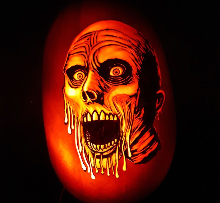 Badass pumpkin carving with a scary face design glowing in the dark. Badass pumpkin carving with a scary face design glowing in the dark.