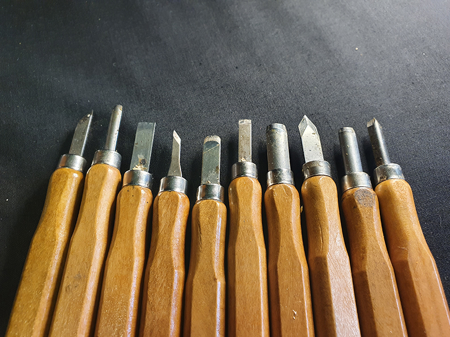 Pumpkin carving tools with wooden handles on a dark surface, perfect for creating a badass pumpkin. Pumpkin carving tools with wooden handles on a dark surface, perfect for creating a badass pumpkin.