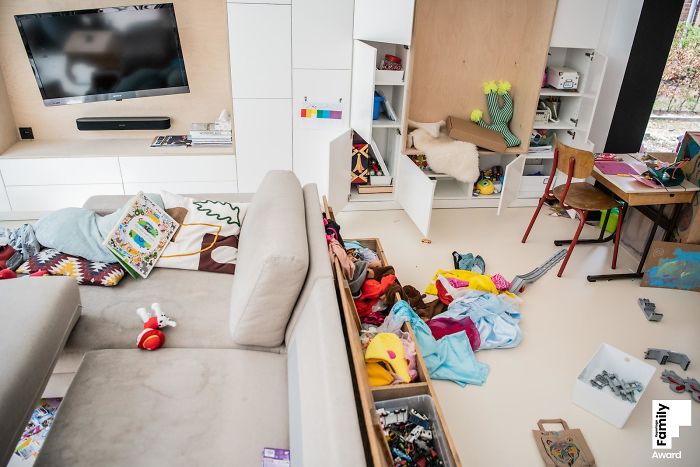 Messy family living room with toys, books, and decorations scattered, illustrating the art of capturing a family moment.