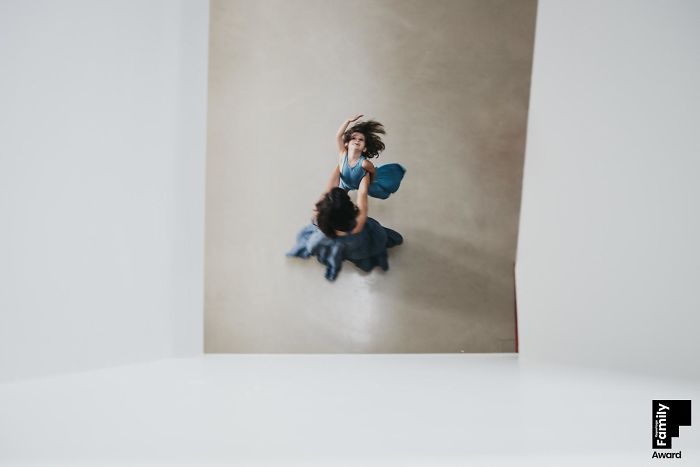 Overhead view of a woman and child dancing together capturing a family moment in an award-winning photo.
