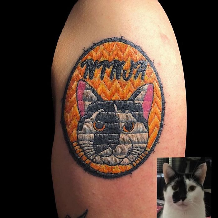 Tattoo resembling a sewn-on patch of a cat on an arm, showcasing impressive artistry.