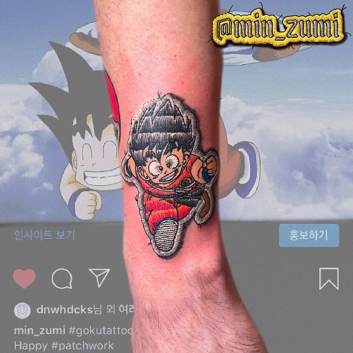 Tattoo of a character resembling a sewn-on patch on a person's leg, showcasing patch-like tattoo artwork.
