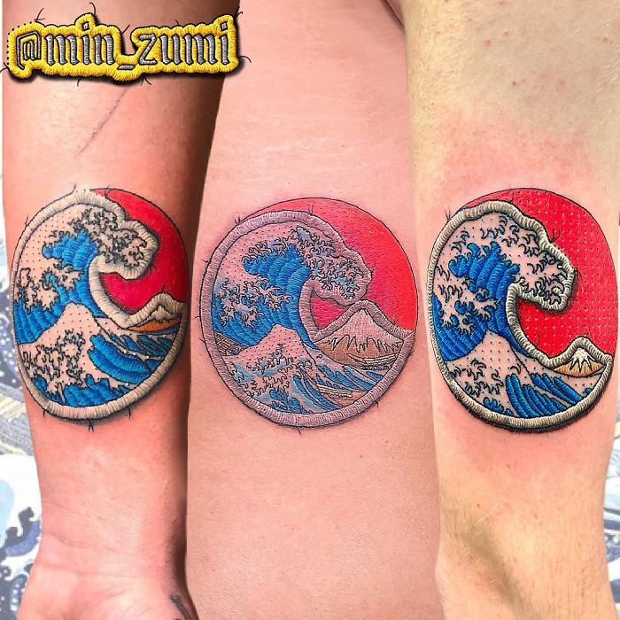 Tattoo looking like a sewn-on patch, featuring a wave design with red and blue colors.