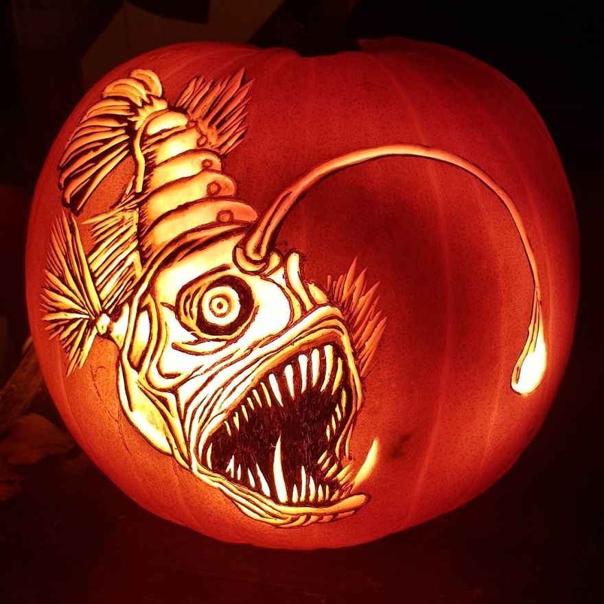 Carved pumpkin featuring an intricate anglerfish design, showcasing creative pumpkin carving skills. Carved pumpkin featuring an intricate anglerfish design, showcasing creative pumpkin carving skills.