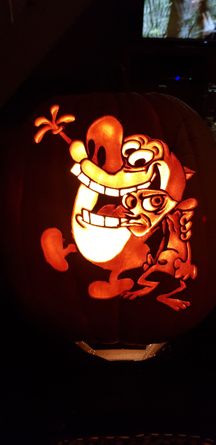 Carved pumpkin with animated characters, glowing in dim light, showcasing unique pumpkin carving techniques. Carved pumpkin with animated characters, glowing in dim light, showcasing unique pumpkin carving techniques.