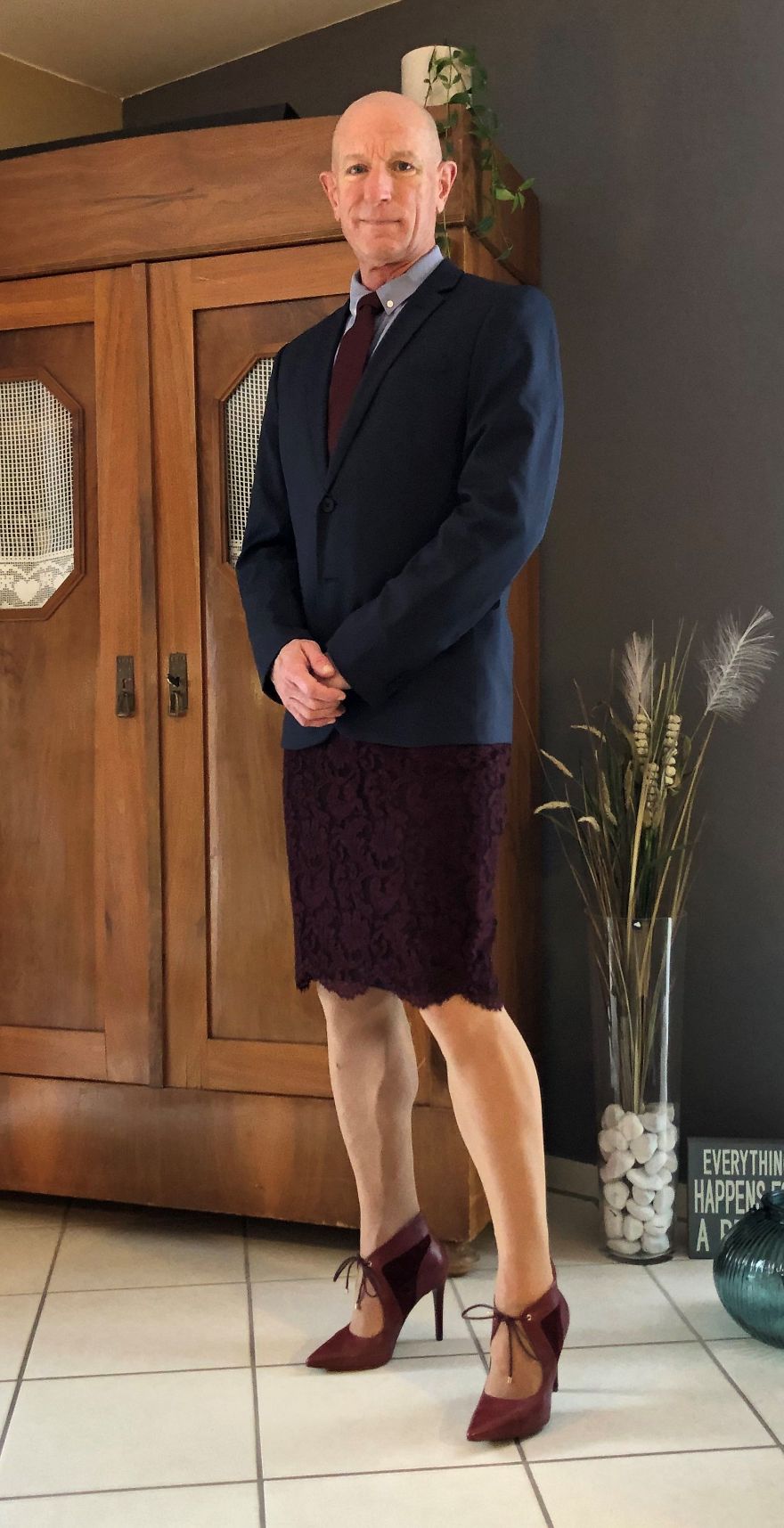 Mark Bryan in a dark suit skirt and high heels