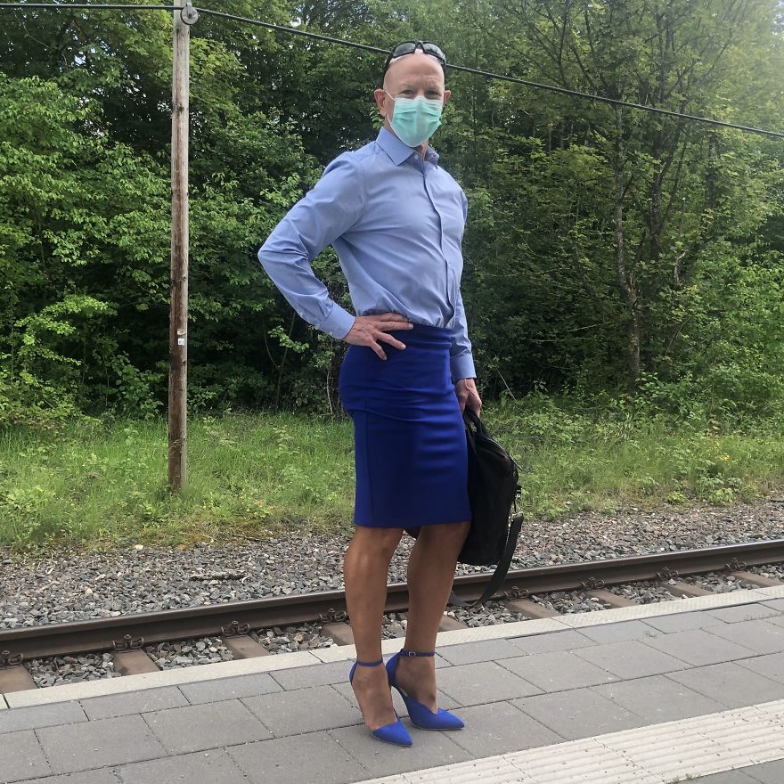 Mark Bryan in a blue outfit with a lighter shirt darker skirt and high heels