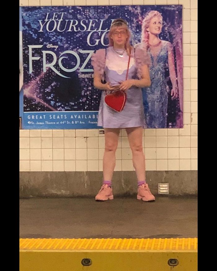 People Sitting Under Signs That Resemble Them