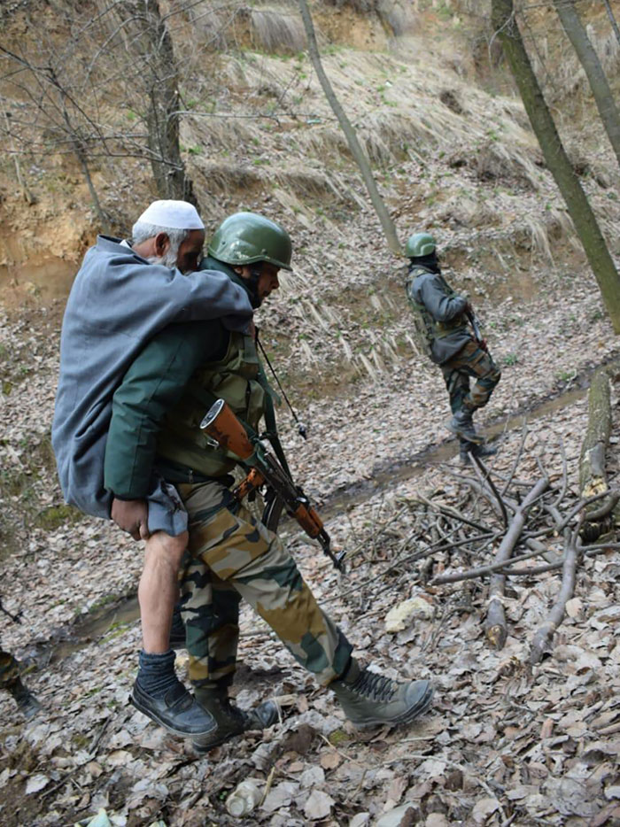 An Old Man While Working In A Field Twisted His Ankle And Was Carried To His Home In The Village Over A Kilometer By Indian Army Troops