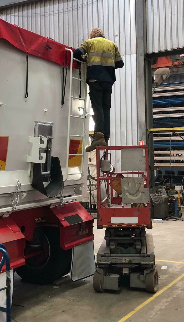 If Only There Was Some Sort Of Moveable Elevating Basket He Could Use, Instead Of Balancing On This Thing