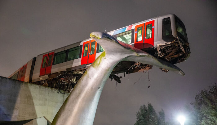 A Tram In The Netherlands Failed To Stop In Time And Broke Through The Emergency Barrier. It's Being Held Up By The Statue Of A Whale's Tail