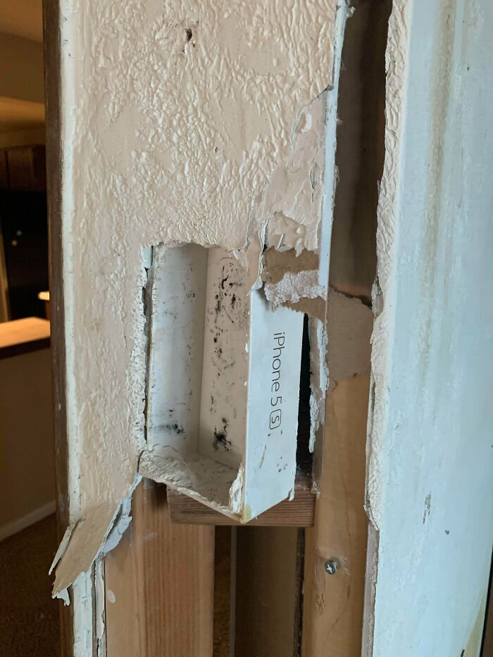 The Wife And I Were Tearing Down A Wall And Saw This And Found This Sub Appropriate As Hell, An iPhone 5 Box Being Used As A Fan Control Holder! Yet Completely Drywalled So You Couldn’t Tell!