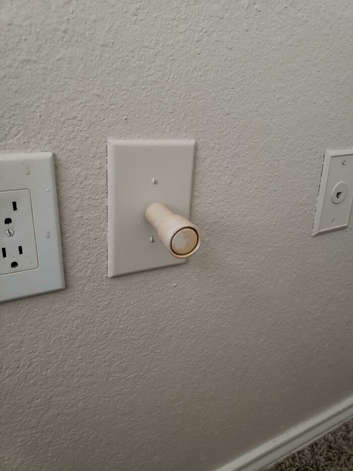 Wall Dongus In Our New Apartment. It Is Loose And Pulling It Out Of The Wall Shows That It's Attached To A Cable. The Little Rondell On The Front Is A Butto