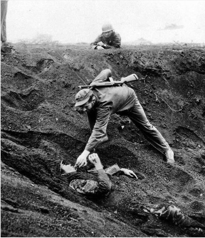 A US Marine Gives A Cigarette To A Japanese Soldier Buried In The Sand. Iwo Jima, 1945