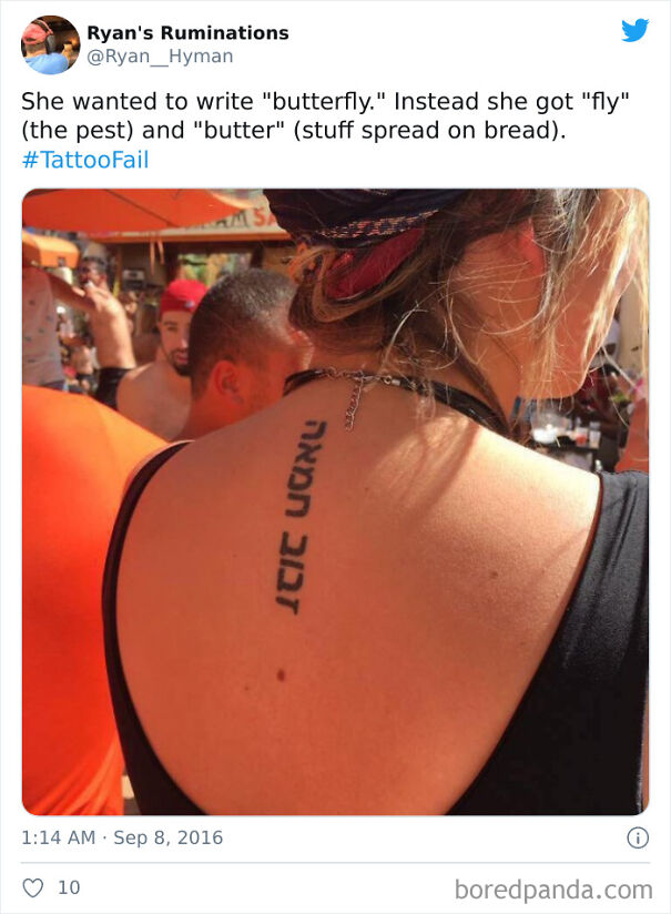 Back tattoo with mistranslated foreign text, humorous tattoo choice in a busy outdoor setting.