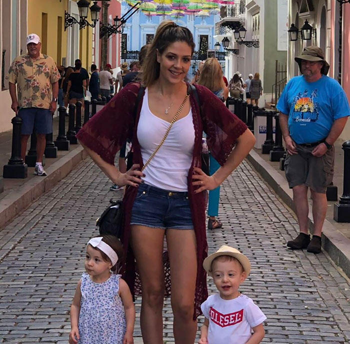Beautiful Family Picture... But What Is The Guy In The Blue Shirt Doing?