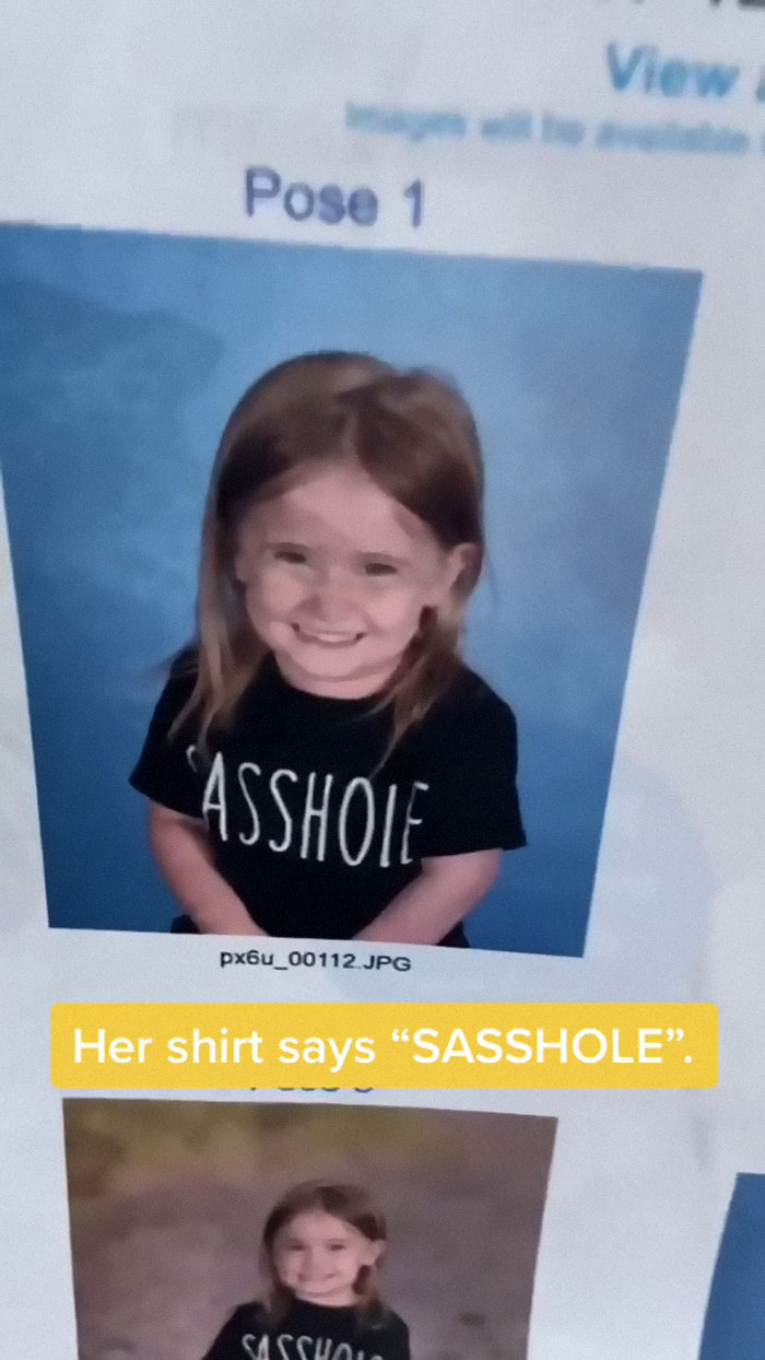 Child in a school photo wearing a humorous "SASSHOLE" shirt, showcasing a hilarious kid photo fail.