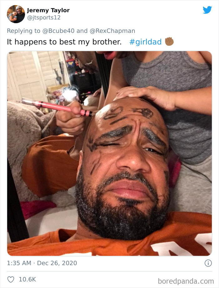 Dad with marker drawings on his face after a playful visit to his daughter's beauty salon at home.