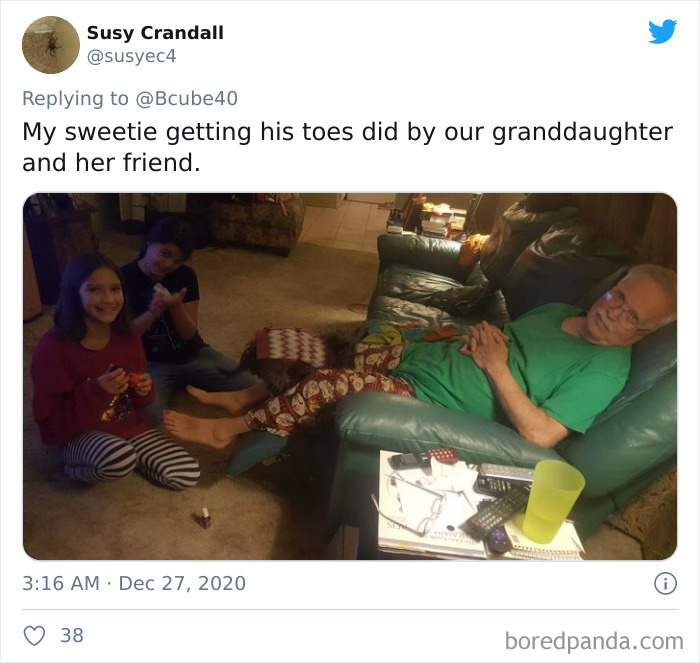 Elderly dad relaxing on couch while two young girls paint his toenails in a home beauty salon setting.