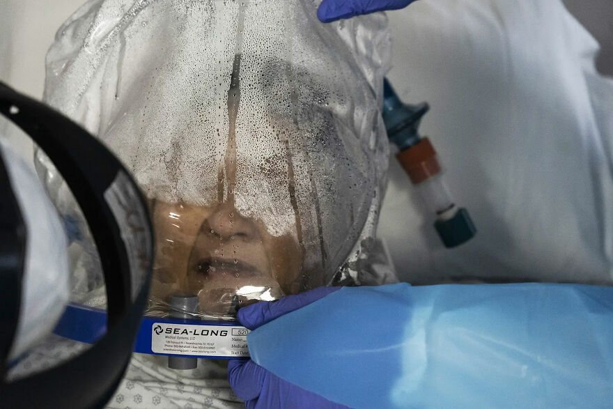 Members Of The Medical Staff Treat A Patient Who Is Wearing A Helmet-Based Ventilator In The Covid-19 Intensive Care Unit On July 28 In Houston