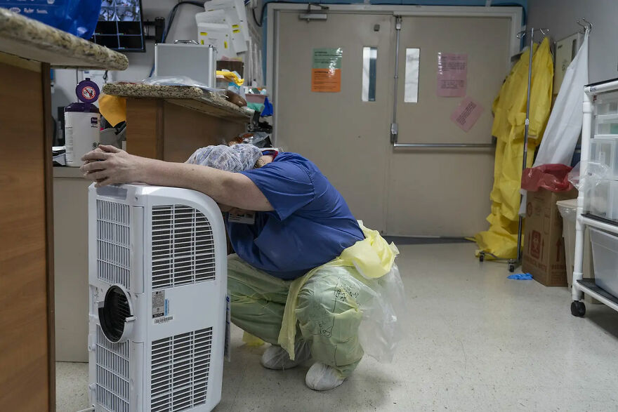 A Medical Staff Member Rests In Front Of A Fan In The Covid-19 Intensive Care Unit On June 30 In Houston