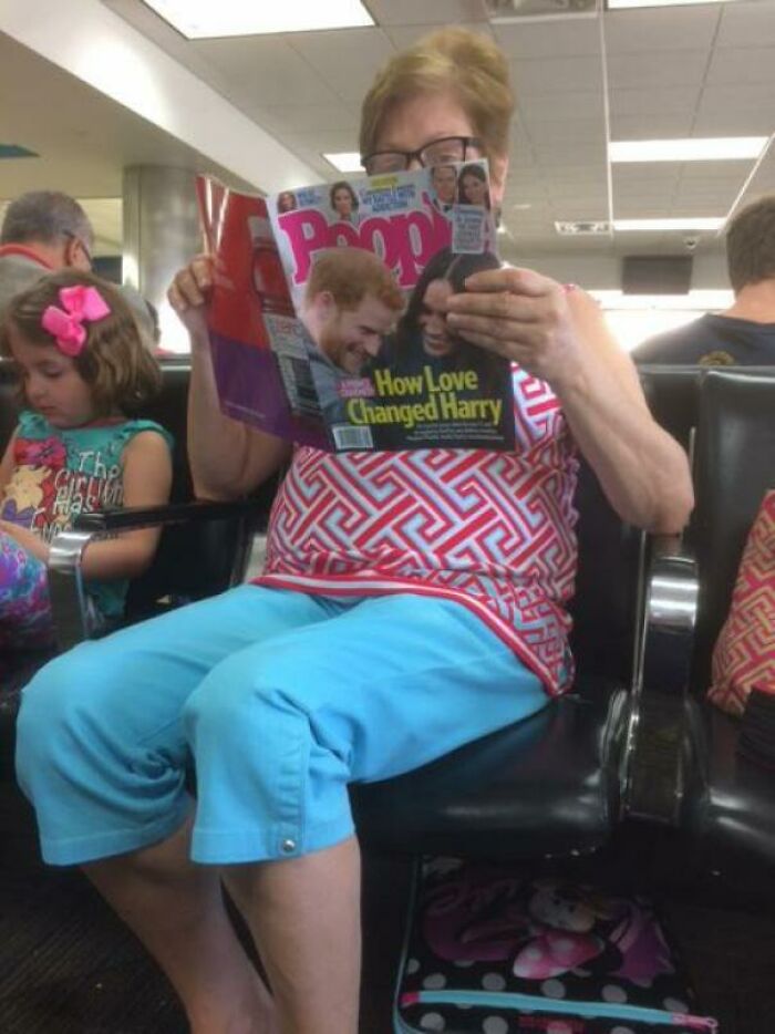 Elderly woman sitting and reading a magazine while a young girl nearby is distracted, showing kids are not born smart humor.